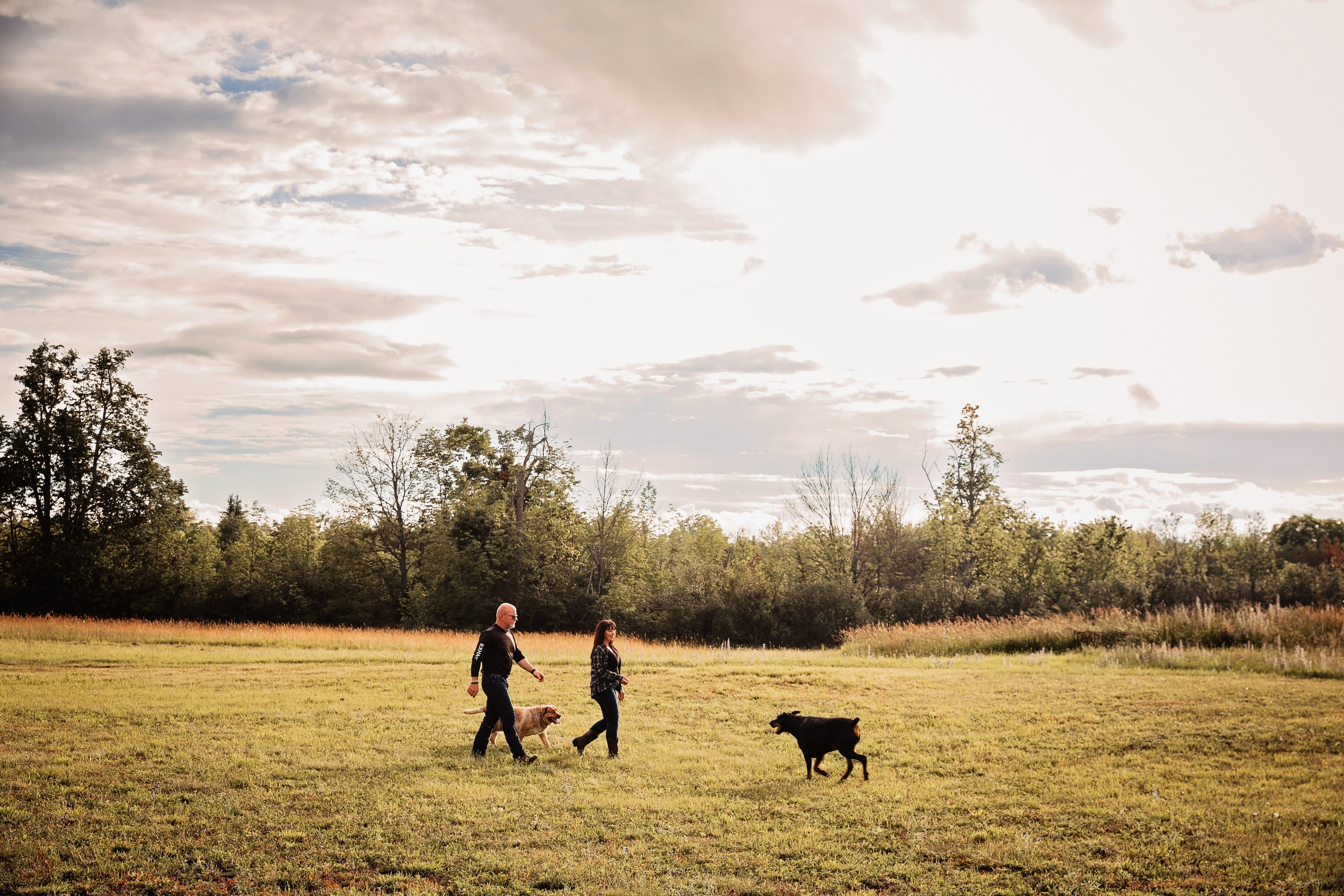 Laurie Riley and Don walking the dogs in Trent Lakes